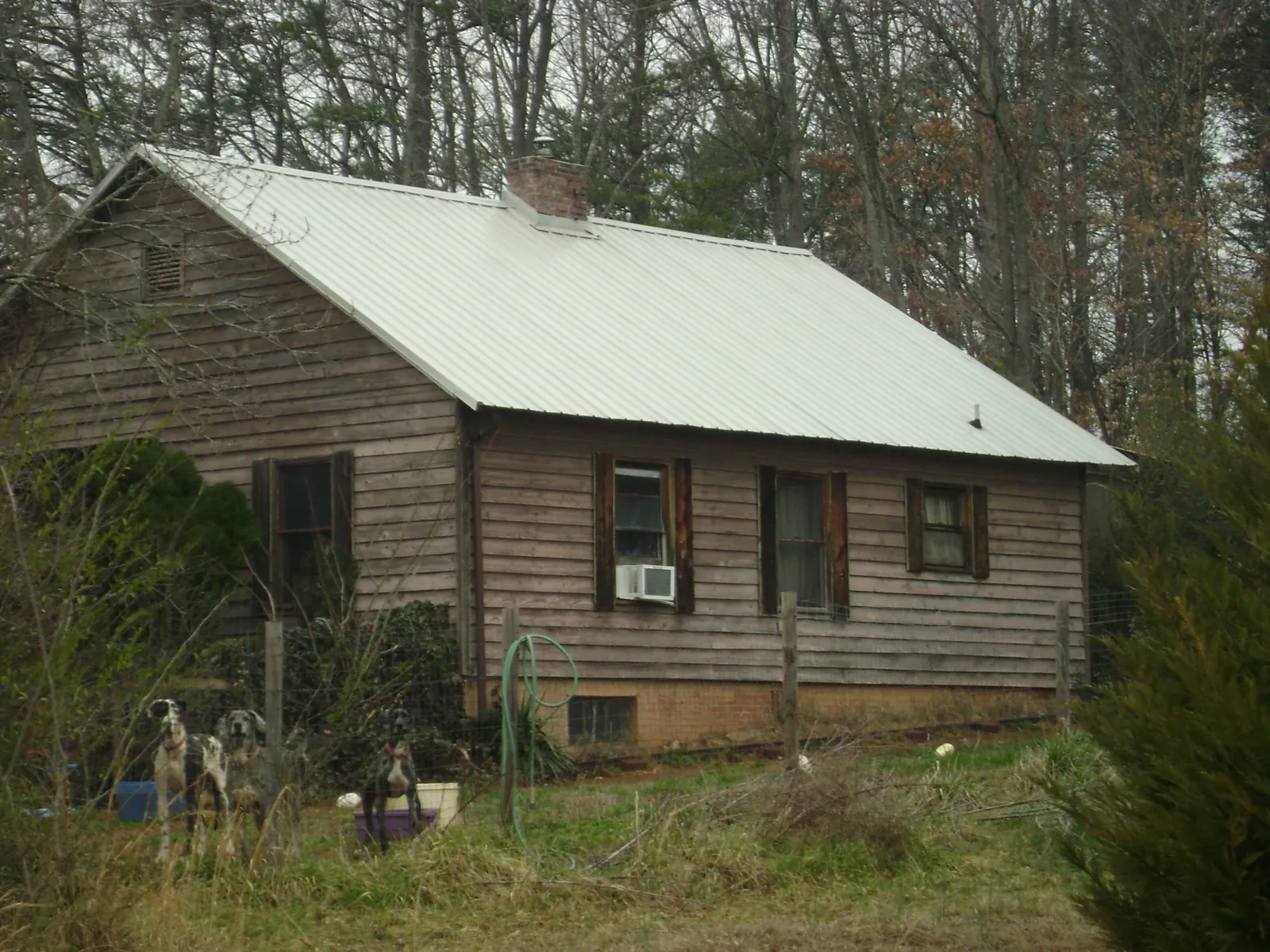 White metal roof on an old wood sided farmhouse, from a Metal Roof Installation job in Anna